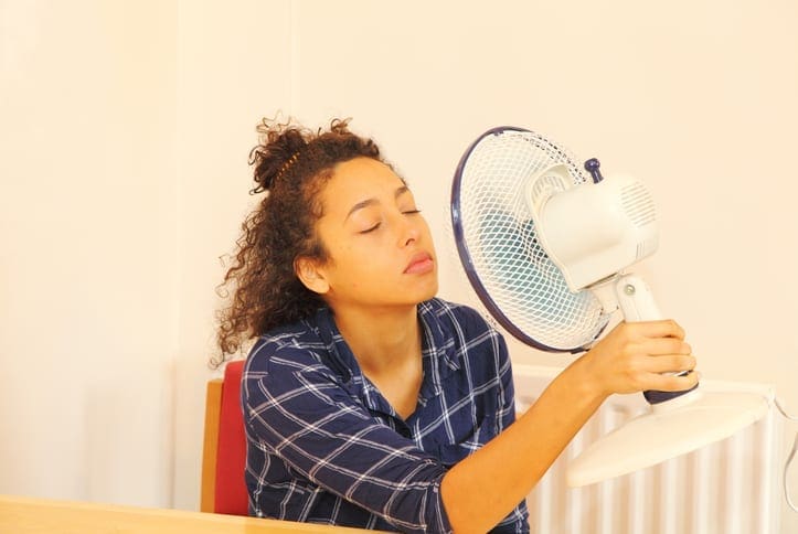 Kevin Robinson's Heating & Cooling | Lancaster, Kershaw, Lugoff, Camden, Indian Land, Heath Springs, SC | teenager cooling down with electric fan