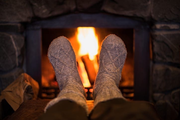 Kevin Robinson's Heating & Cooling | Lancaster, Kershaw, Lugoff, Camden, Indian Land, Heath Springs, SC | Feet in wool socks near fireplace